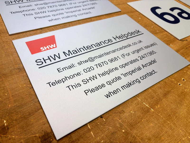 Custom printed aluminium SHW Maintenance Helpdesk sign displaying building maintenance contact information