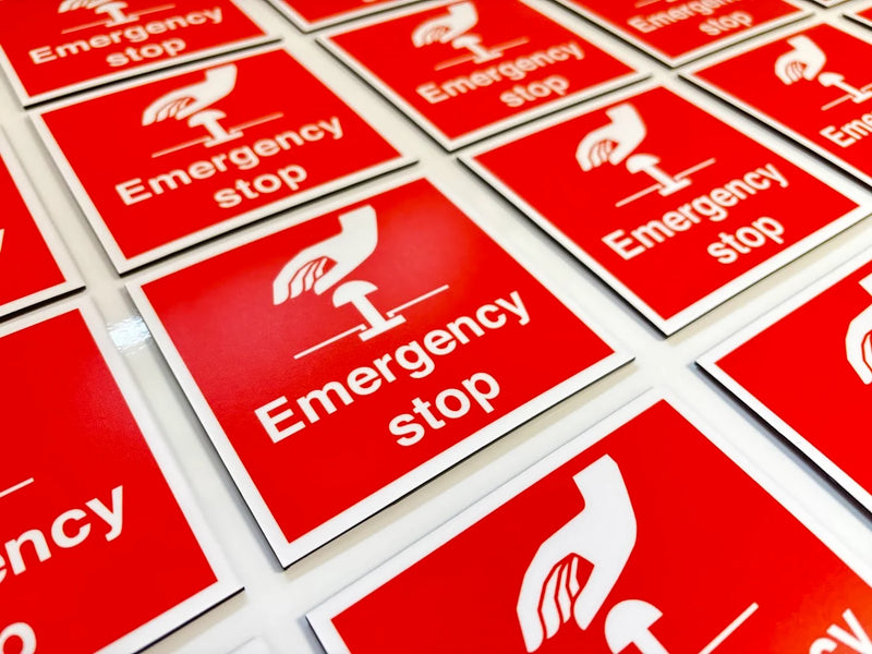 Red and white Emergency stop signs with a hand pressing a stop button pictogram